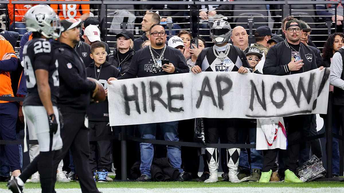 Las Vegas Raiders fans hold a sign