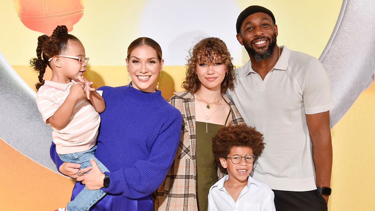 Allison Holker and her family on the red carpet and smiling