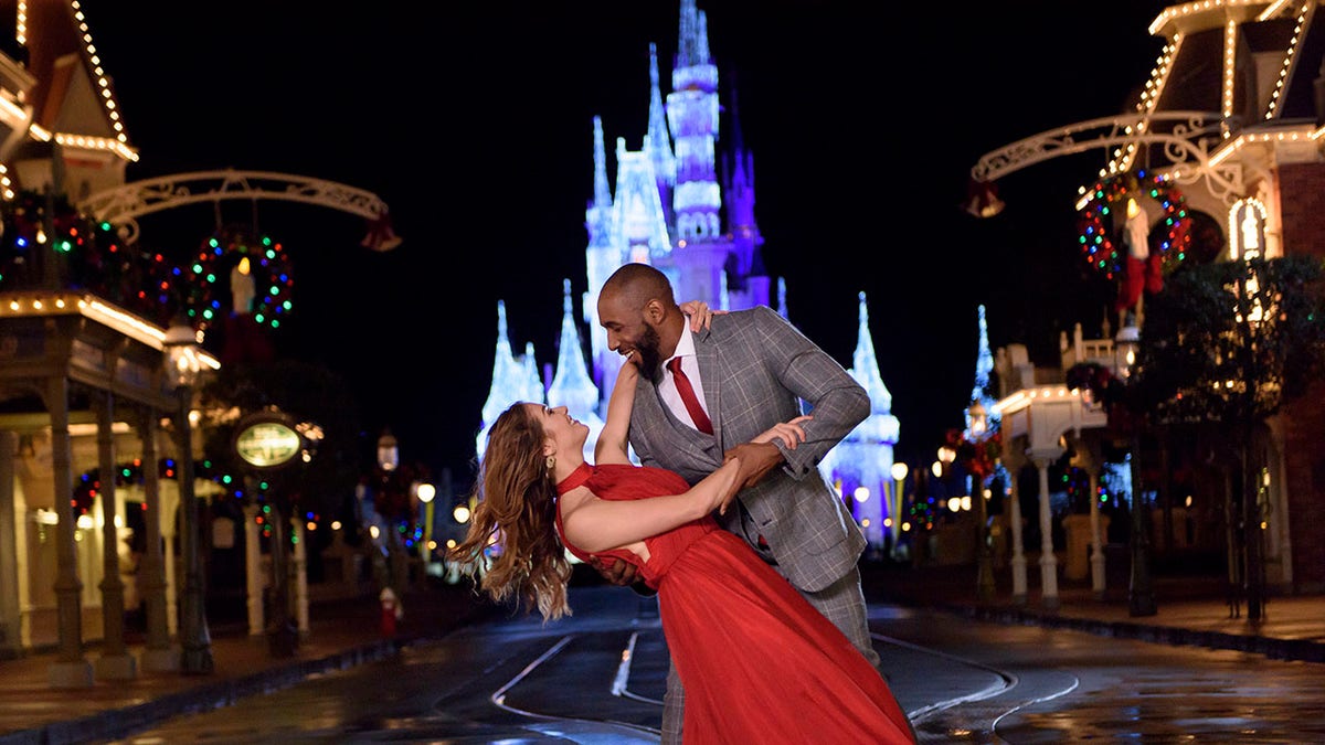 Allison Holker and Stephen Twitch Boss dancing in front of a Disney Castle