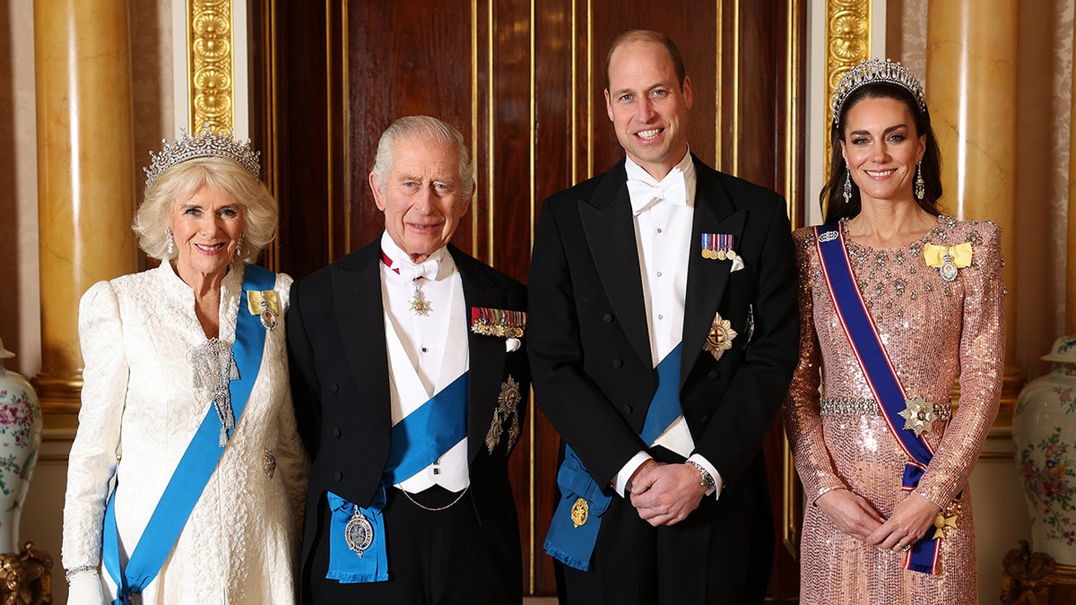 The British royal family standing together in formal wear and smiling