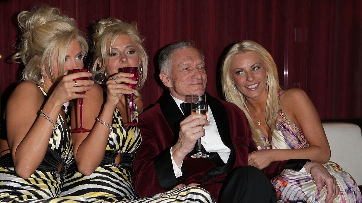 Hugh Hefner surrounded by twins and his wife Crystal Hefner