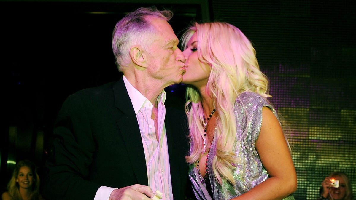 Hugh Hefner kissing Crystal Hefner