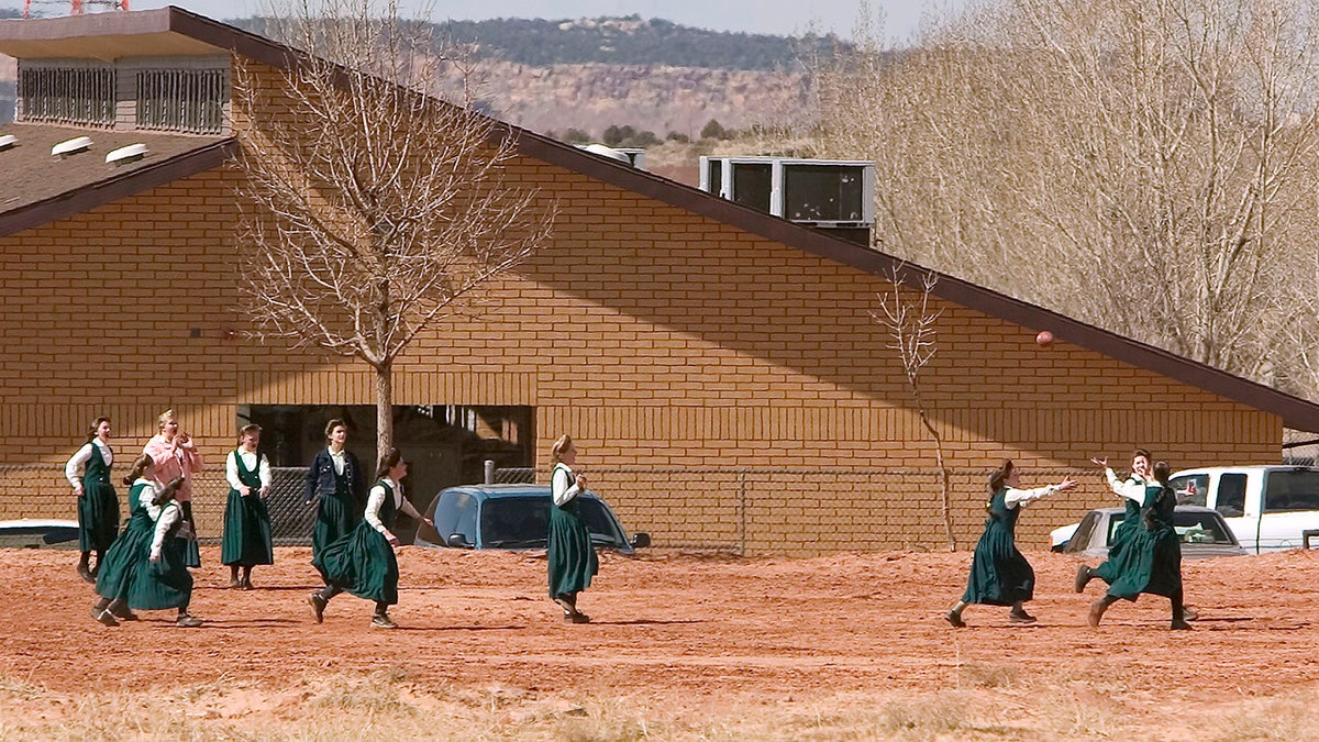 Several young FLDS members playing in a field
