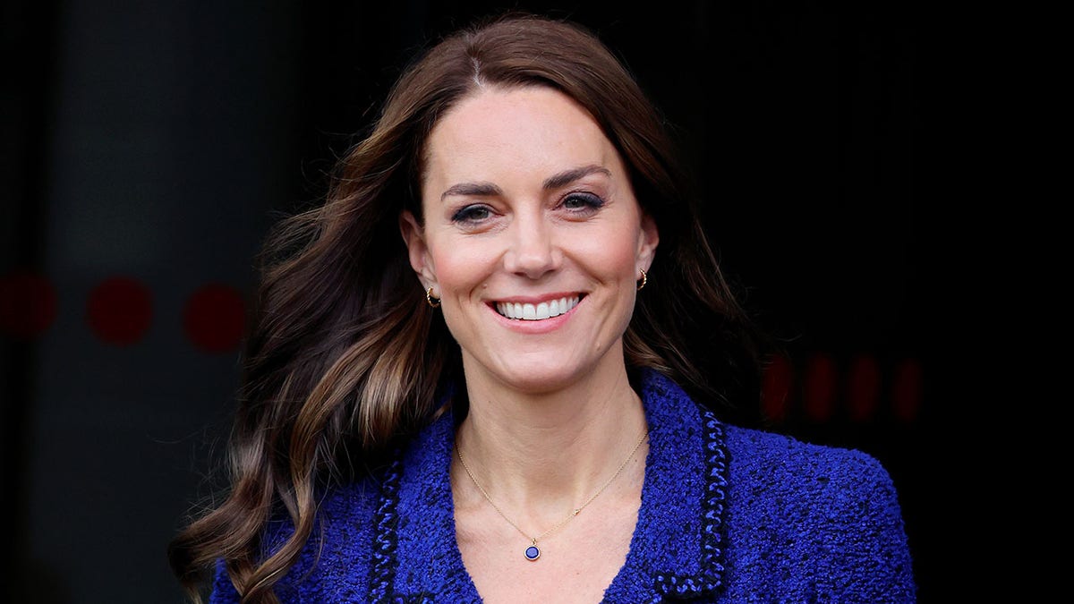Close-up of Kate Middleton smiling in a blue dress