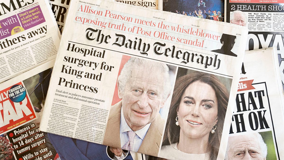 newspapers stacked on top of each other showing King Charles and Kate Middleton