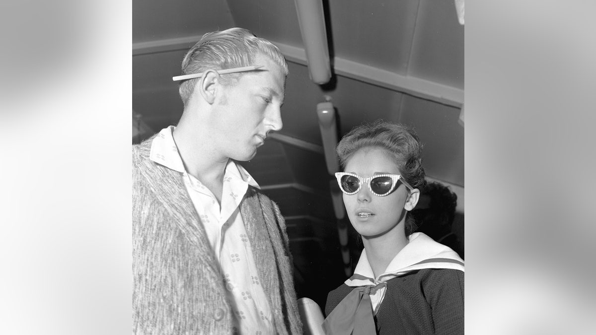 Myra Lewis wearing sunglass with Jerry Lee Lewis looking at her