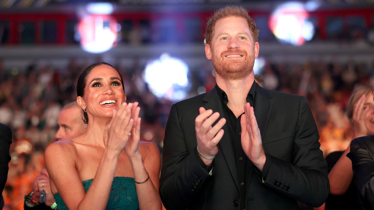 Prince Harry and Meghan Markle applauding