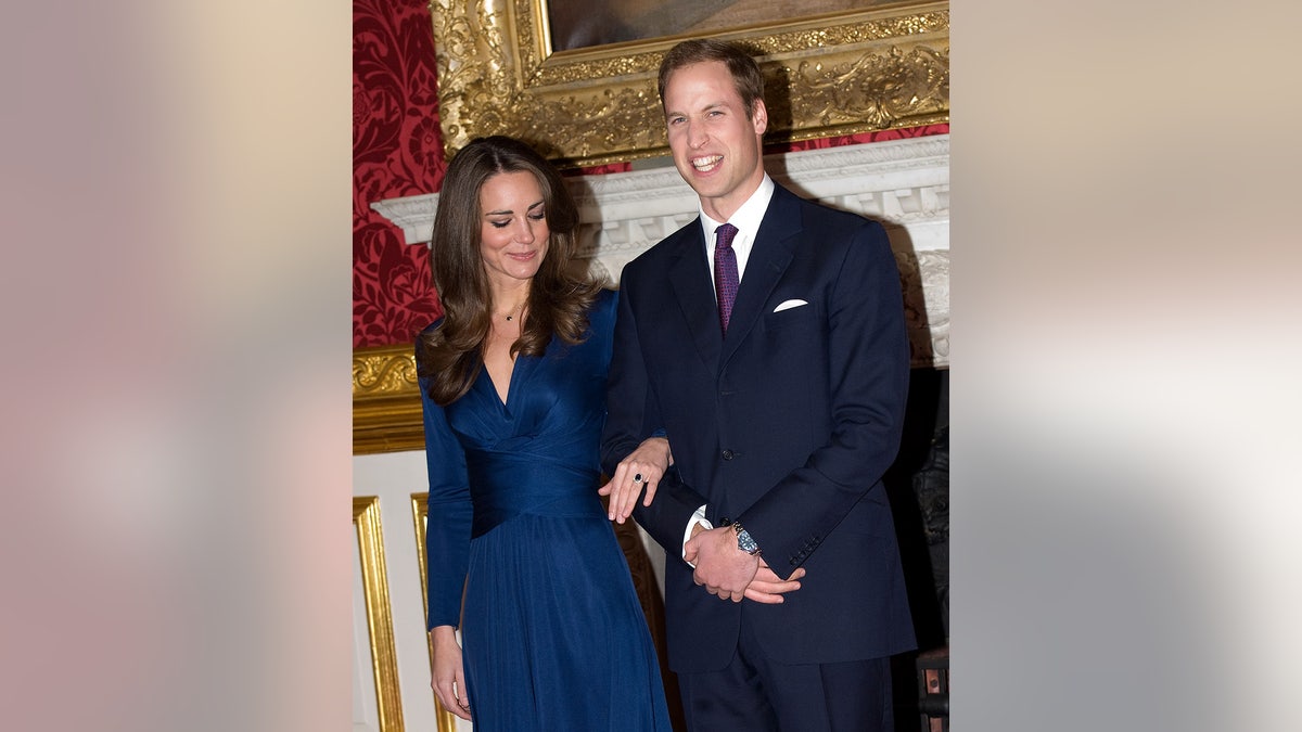 Kate Middleton admiring her engagement ring with Prince William smiling