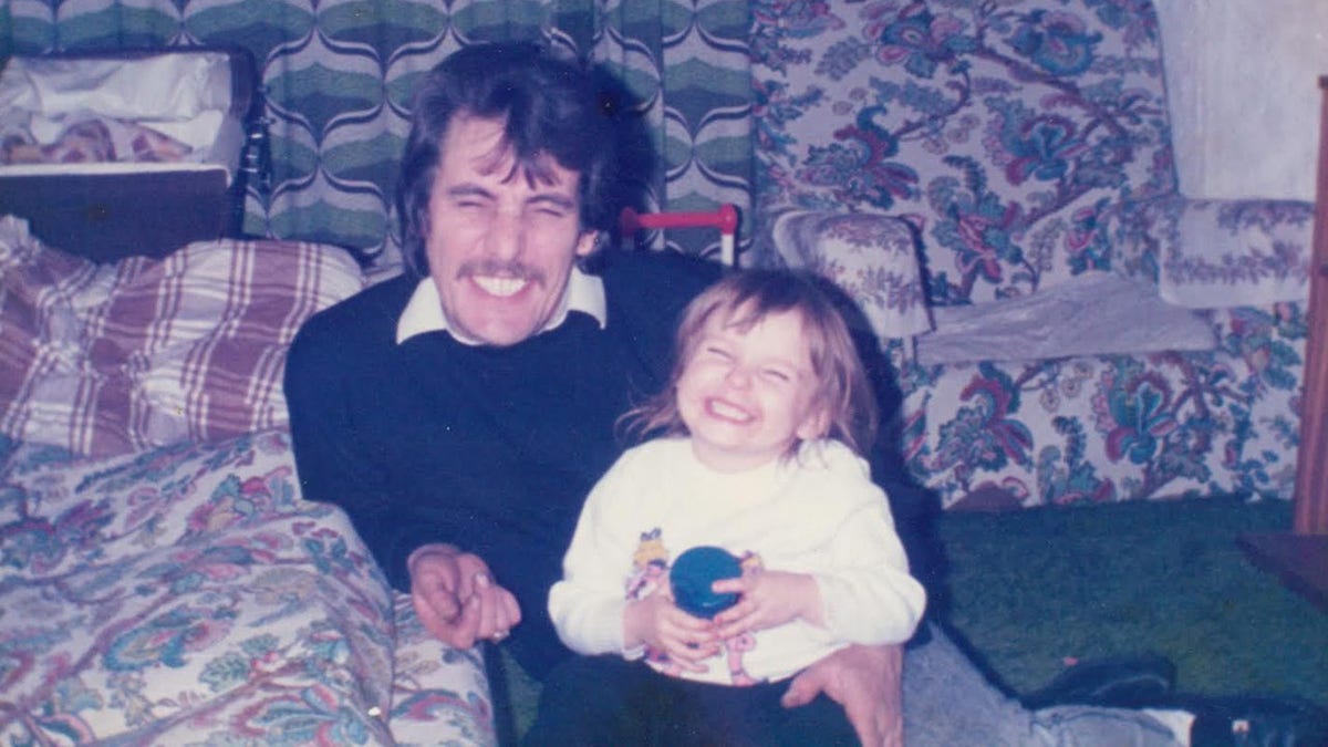 A young Crystal Hefner smiling with her father
