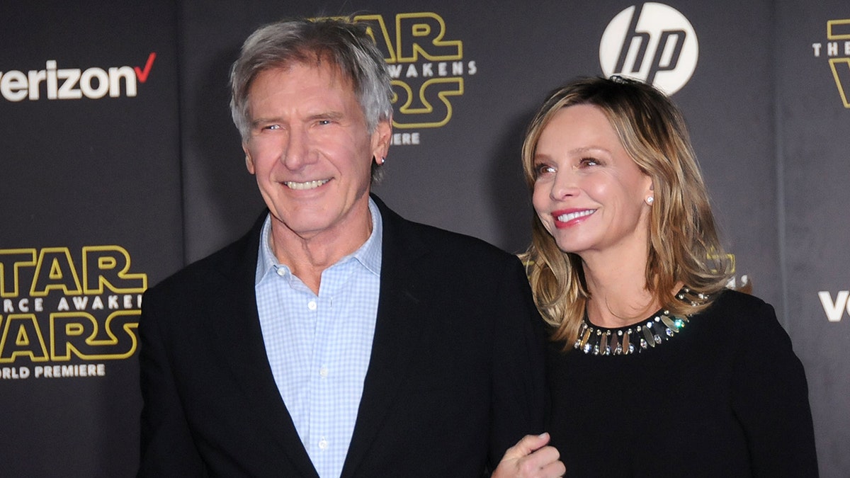 Calista Flockhart holding Harrison Ford's arm on the red carpet