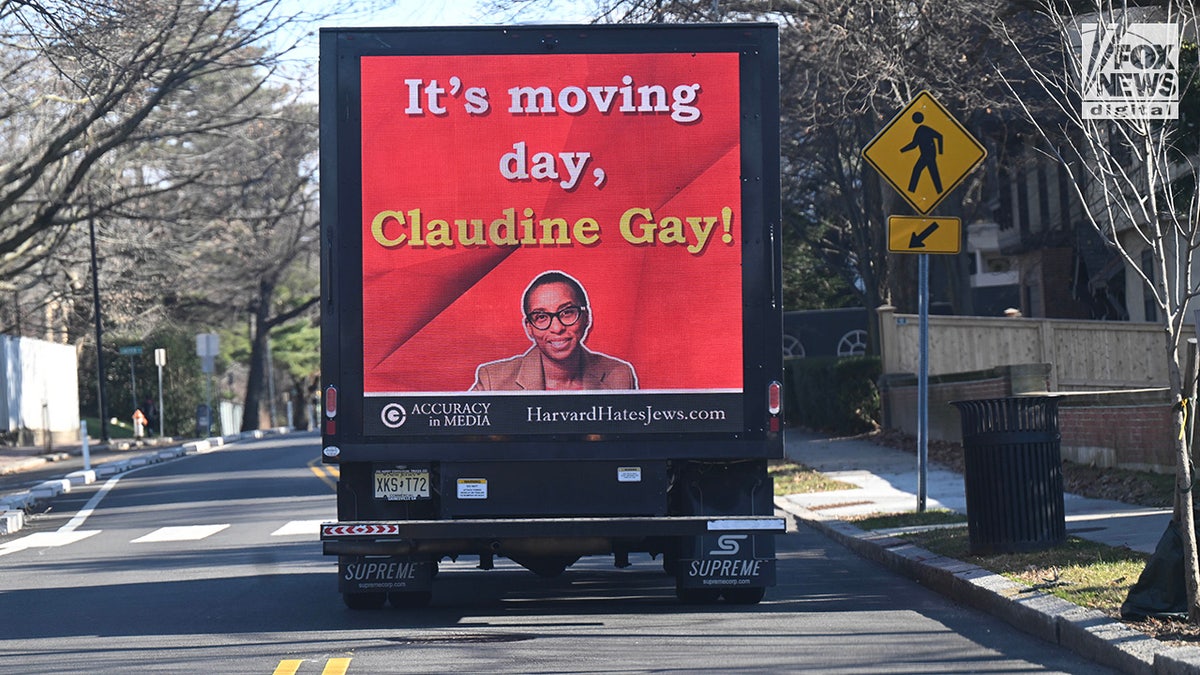 A video board monitor truck drives around the neighborhood of the Harvard University President’s house