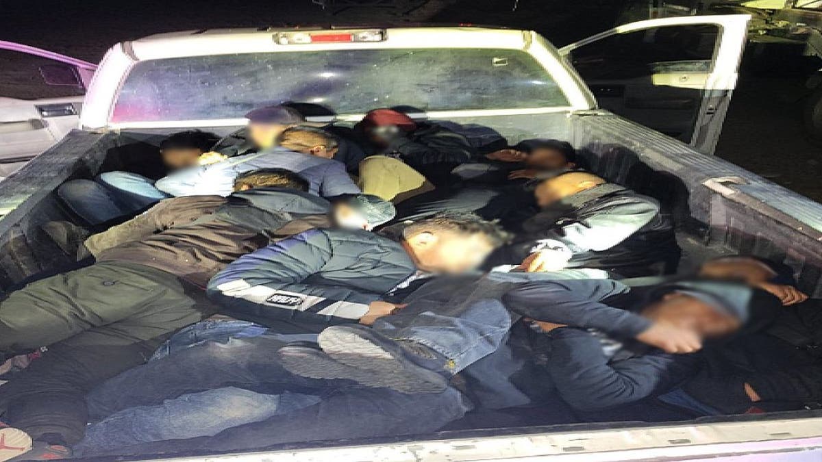 Several illegal migrants packed into the back of a pick up truck