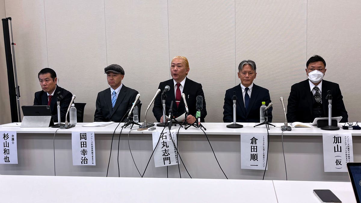 Lawyer Kazuya Sugiyama, right, and Shimon Ishimaru, center, sit with three alleged victims of entertainment mogul Johnny Kitagawa as they speak to reporters during a news conference on Jan. 15, 2024. 