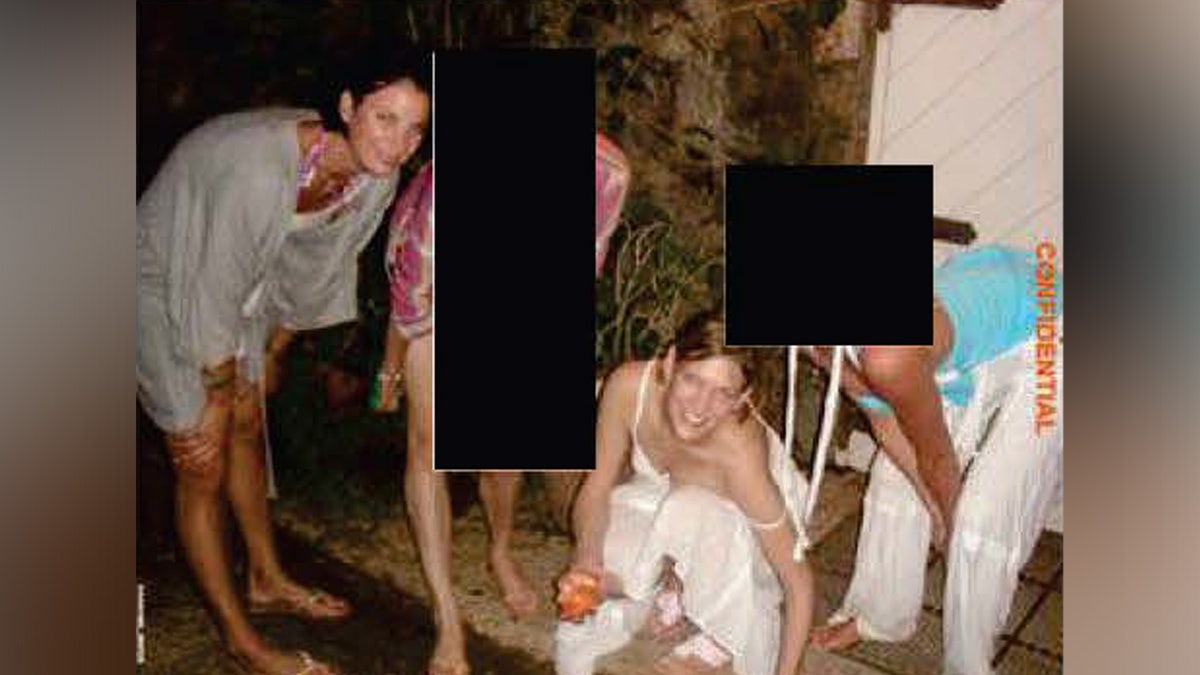 A photo of evidence that has been partially redacted shows various girls smiling for a picture on Jeffrey Epstein's Little St James Island.