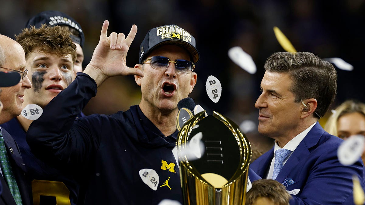 Jim Harbaugh with the trophy