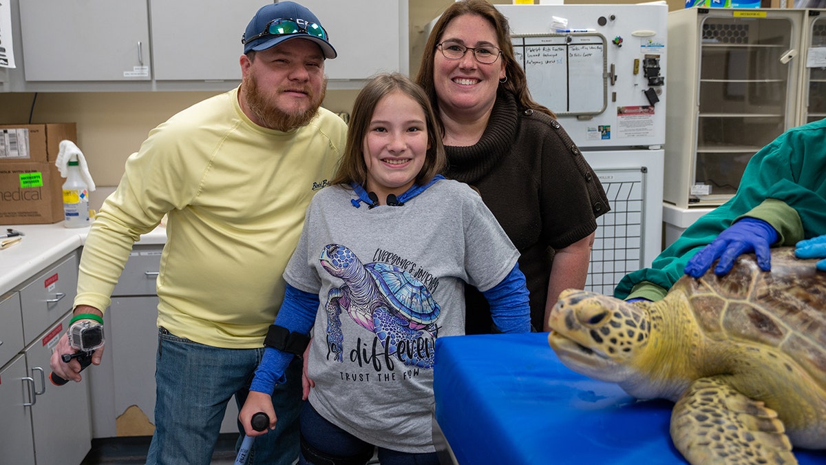 kendall and parents with sea turtle