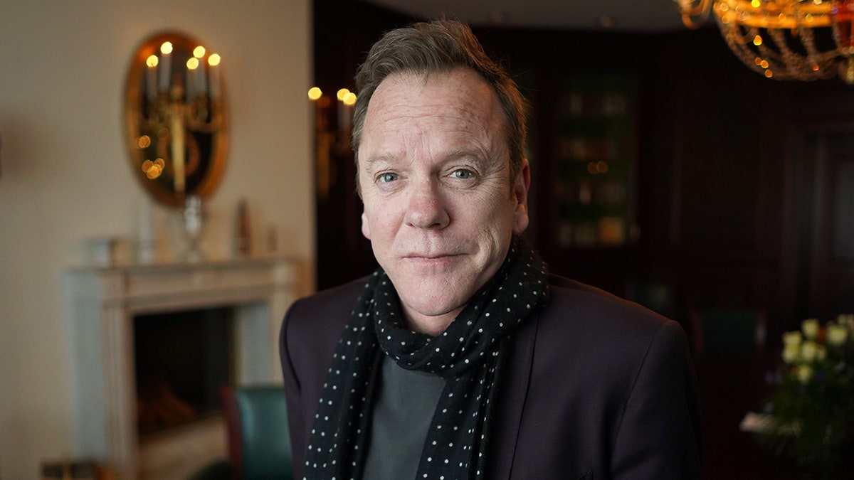 Kiefer Sutherland sitting in a parlor