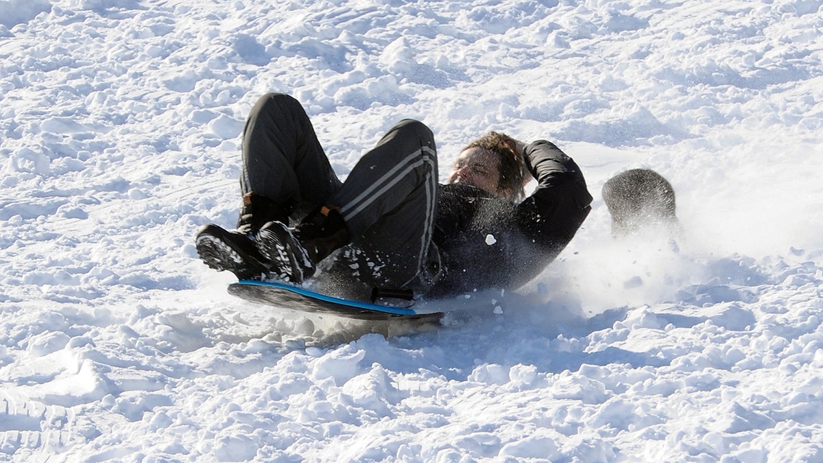 Man sledding on Toronto hill