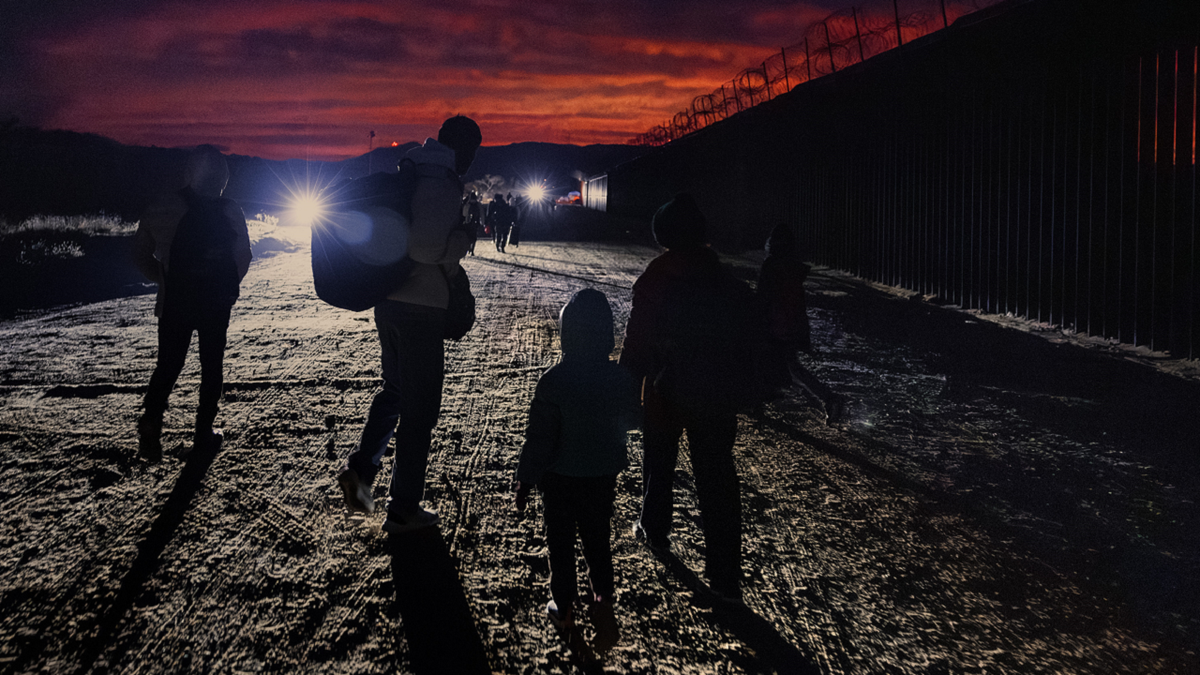 Migrants approach U.S.-Mexico border fence