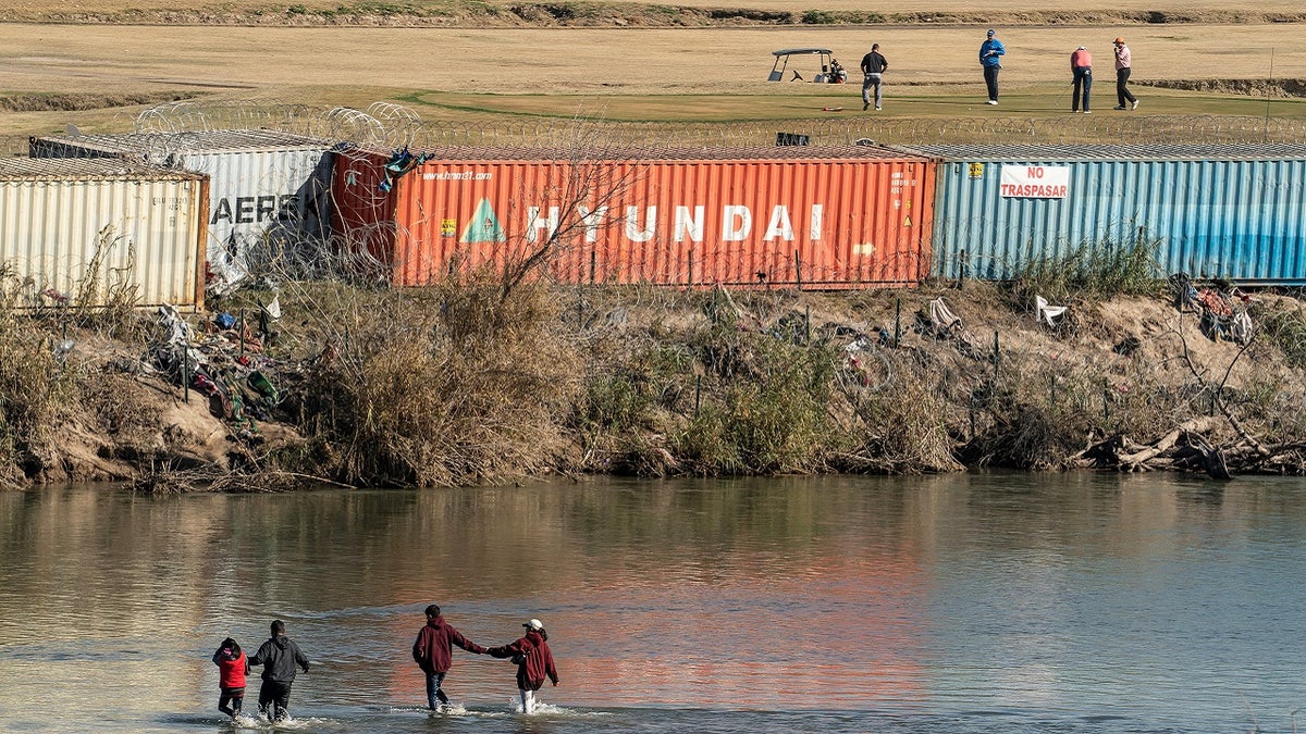 Migrants cross Rio Grande in Eagle Pass, Texas