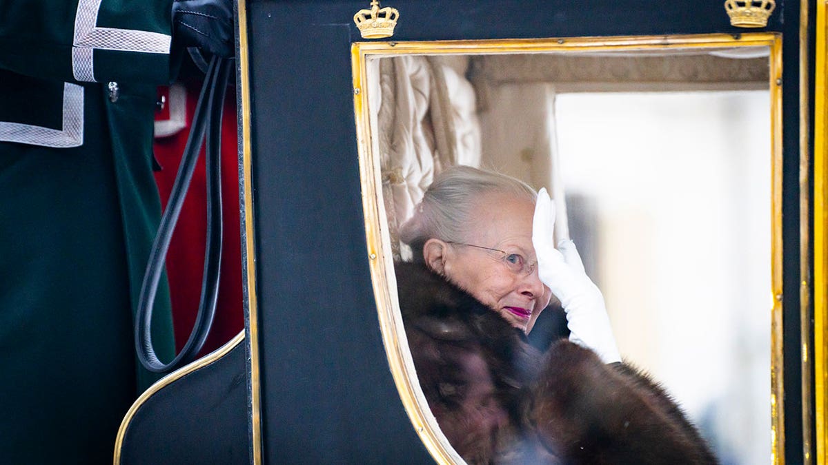 Queen Margrethe escorted