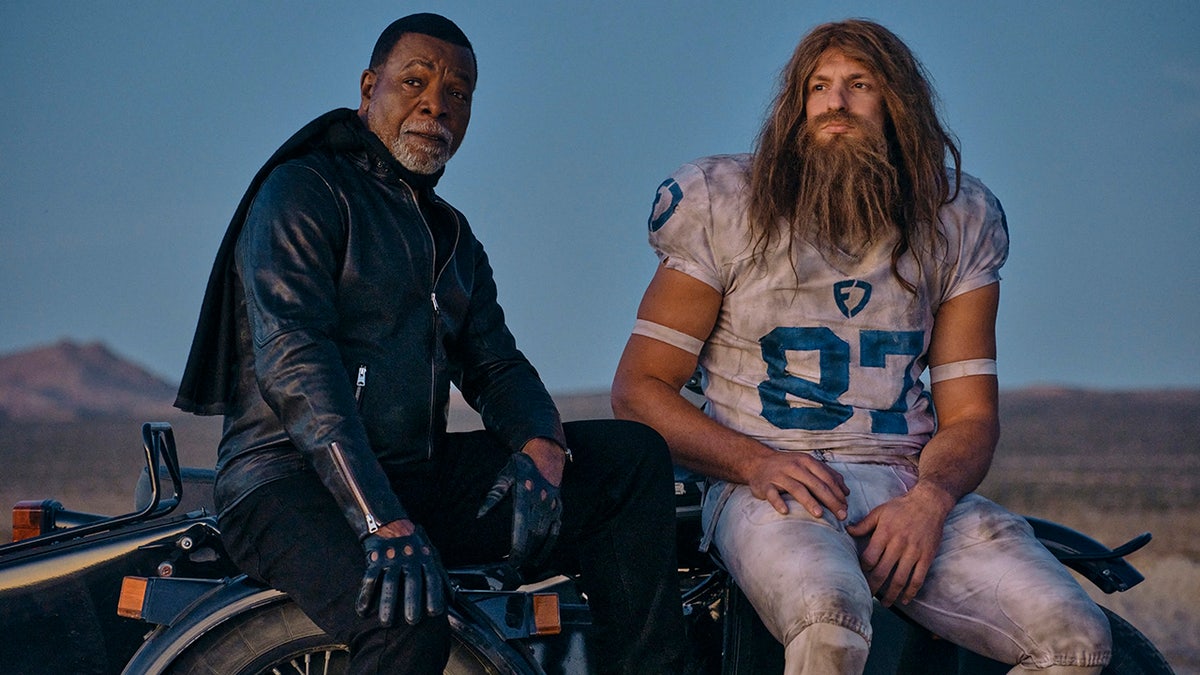 Rob Gronkowski and Carl Weathers sit on motorcycle