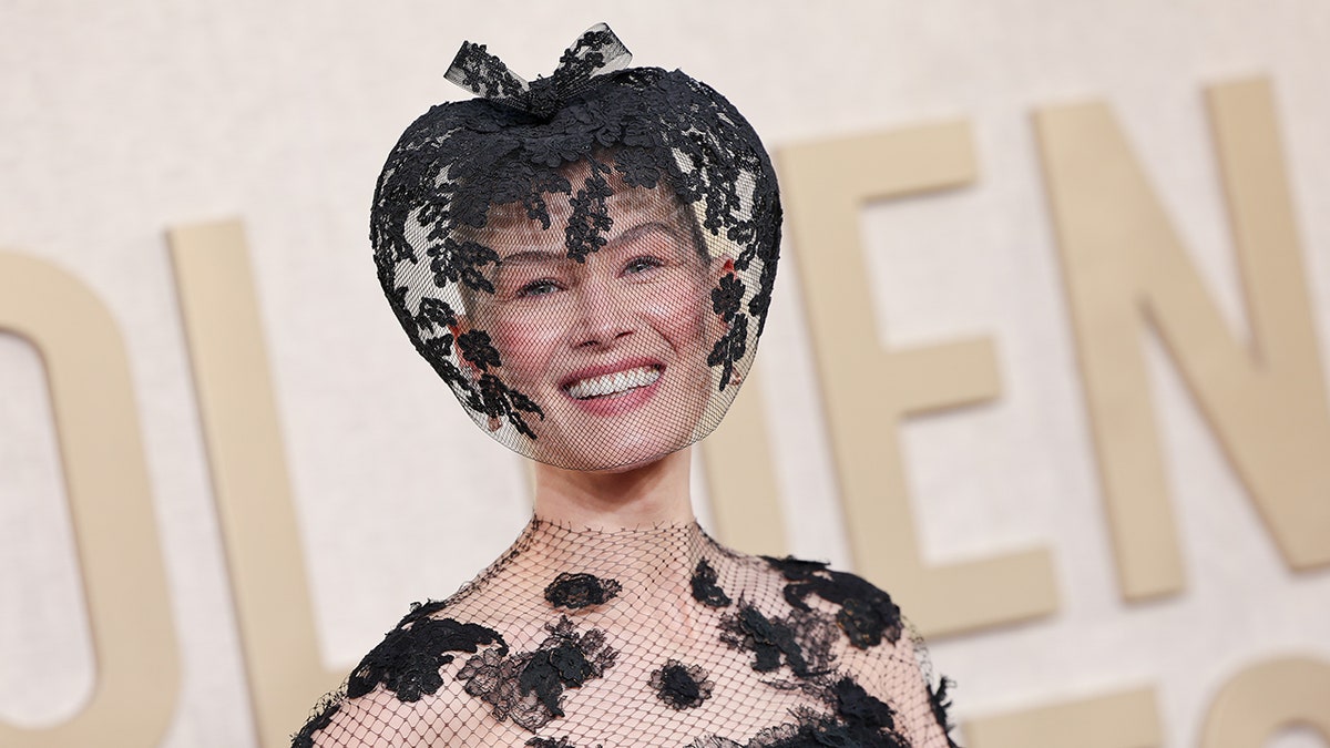 Close up of Rosamund PIke smiling with the veil