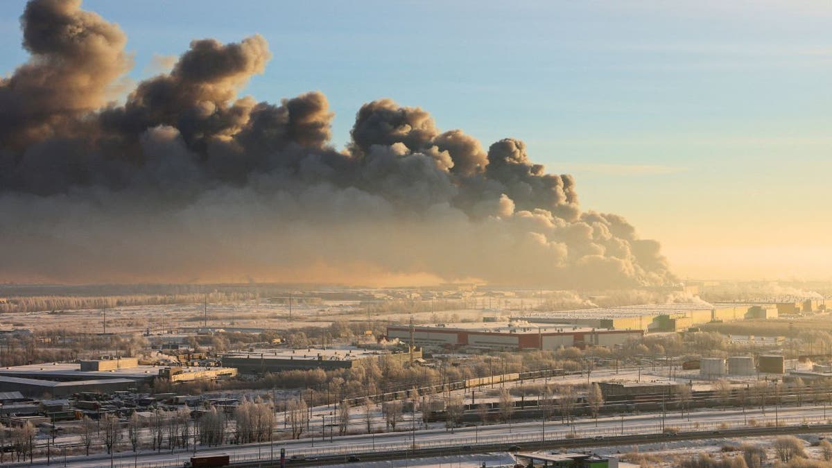 Heavy smoke rises above a burning warehouse in Russia