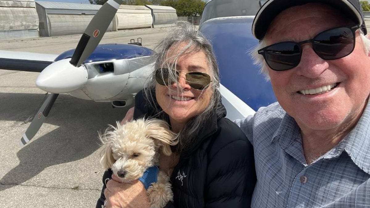 Treat and Pam Williams in front of airplane