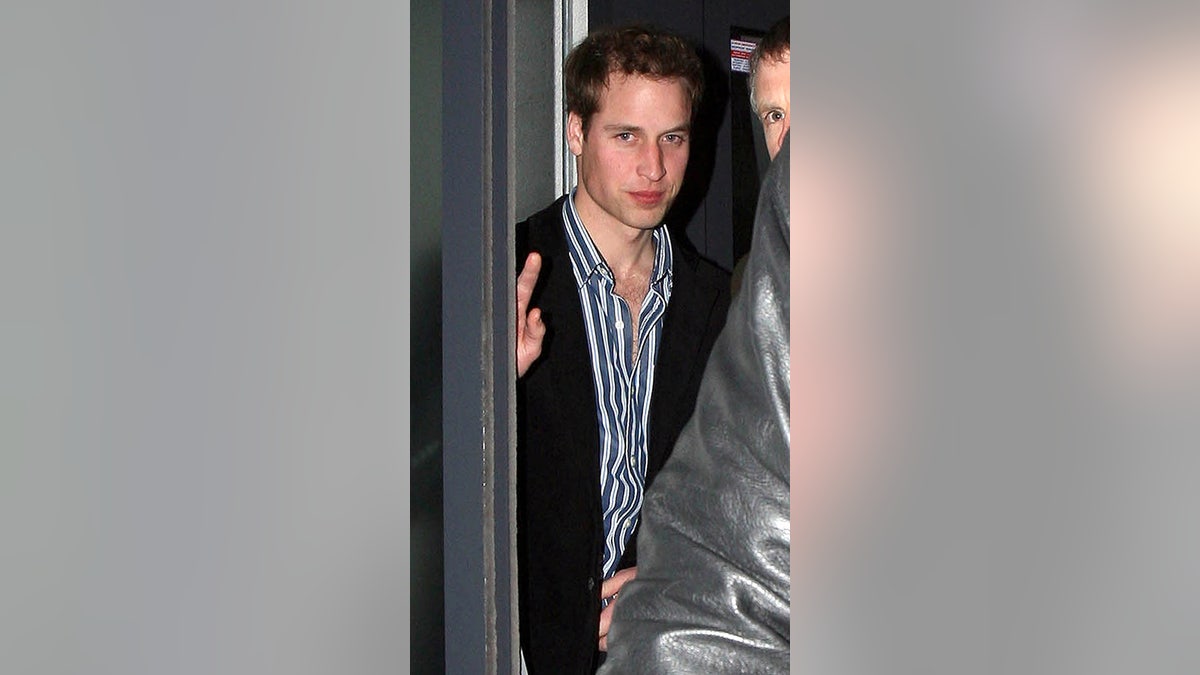 Prince William wearing a striped shirt and a blazer