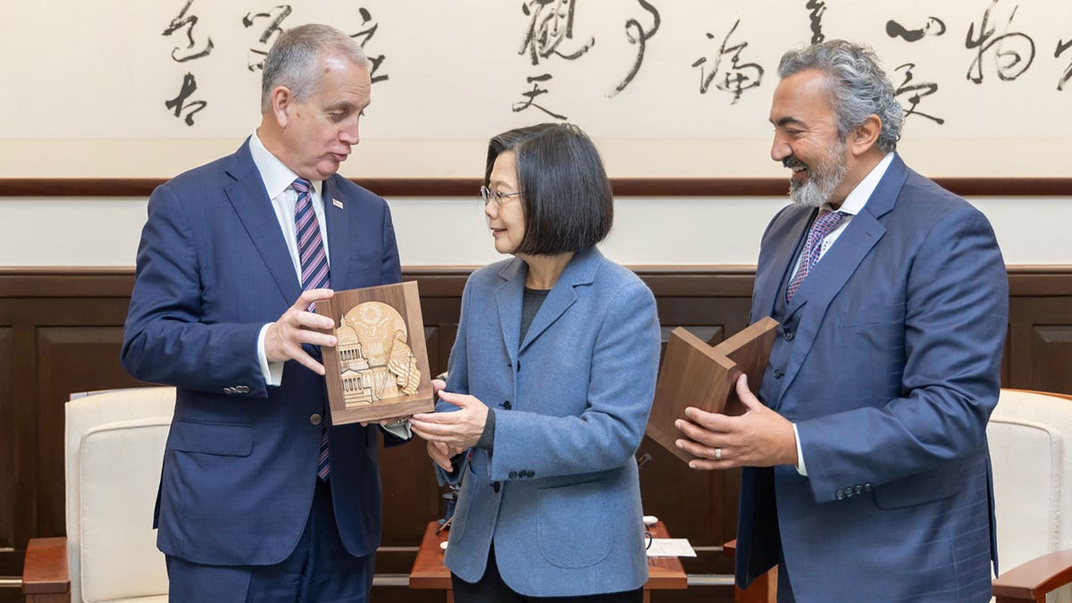 Taiwan President Tsai Ing-wen exchanges gifts with U.S. Rep. Mario Diaz-Balart, and Rep. Ami Bera