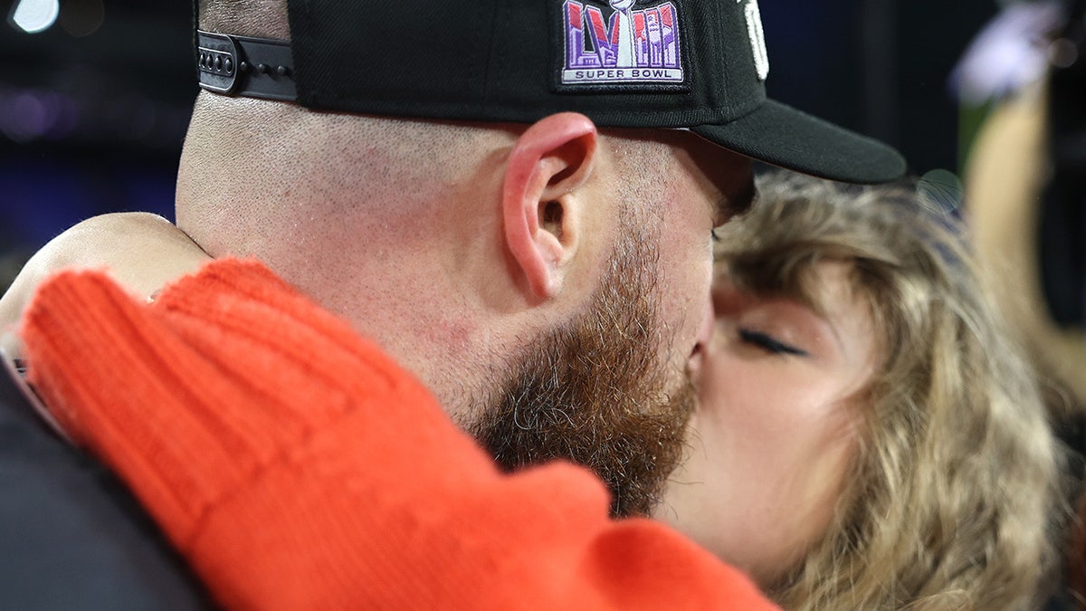 Travis Kelce shares a kiss with Taylor Swift