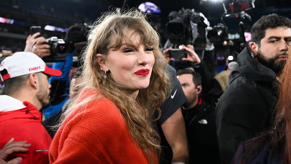 Taylor Swift walks off the field after the Kansas City Chiefs won the AFC Championship football game