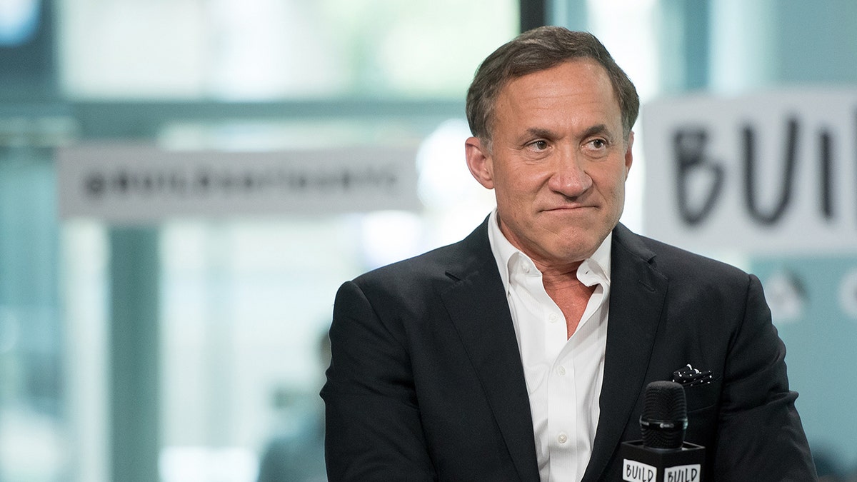 Terry Dubrow sitting onstage with a serious look