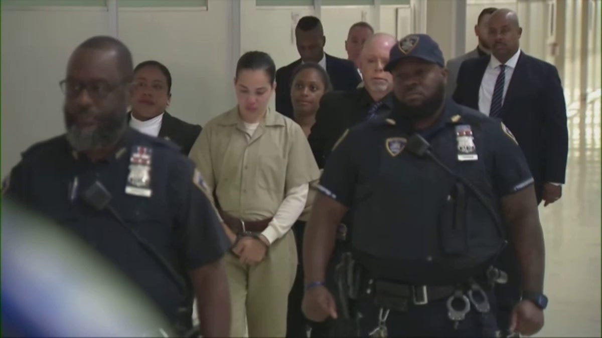 Grei Mendez in prison jumpsuit and handcuffs