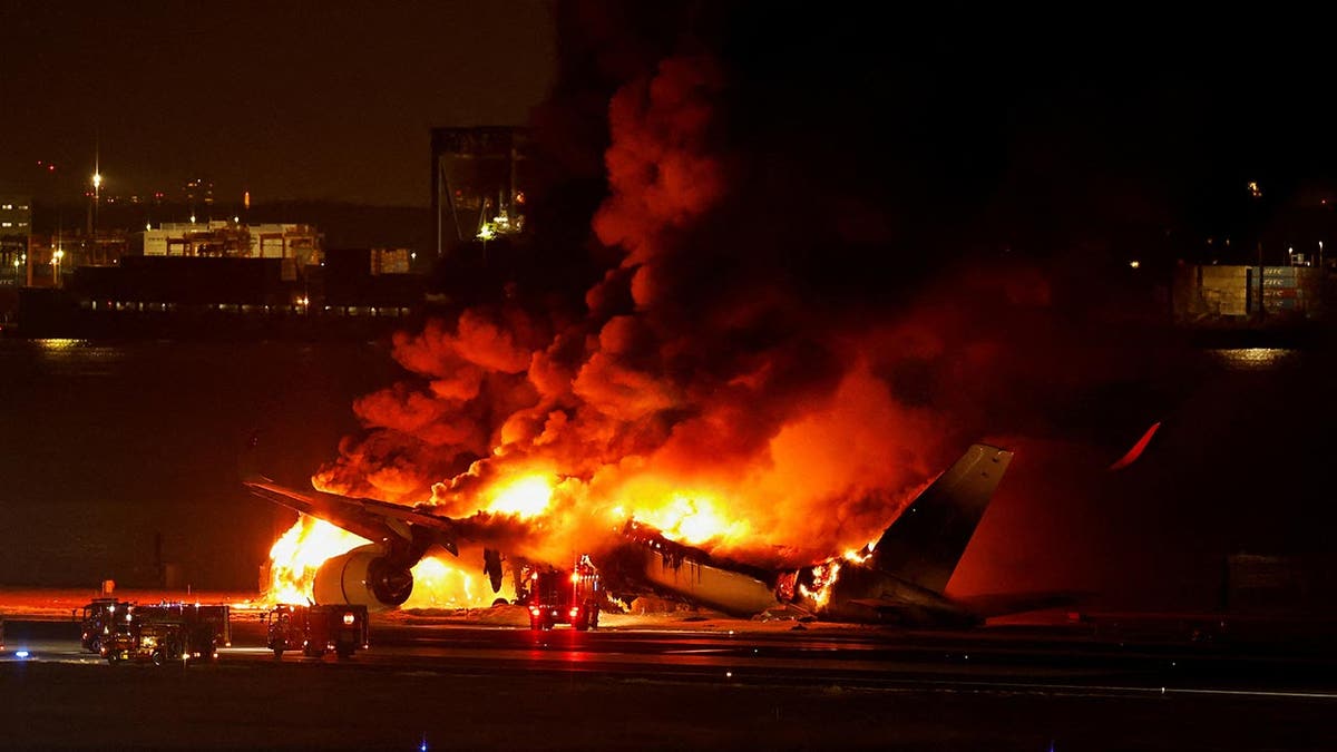Plane on fire on the tarmac in Tokyo