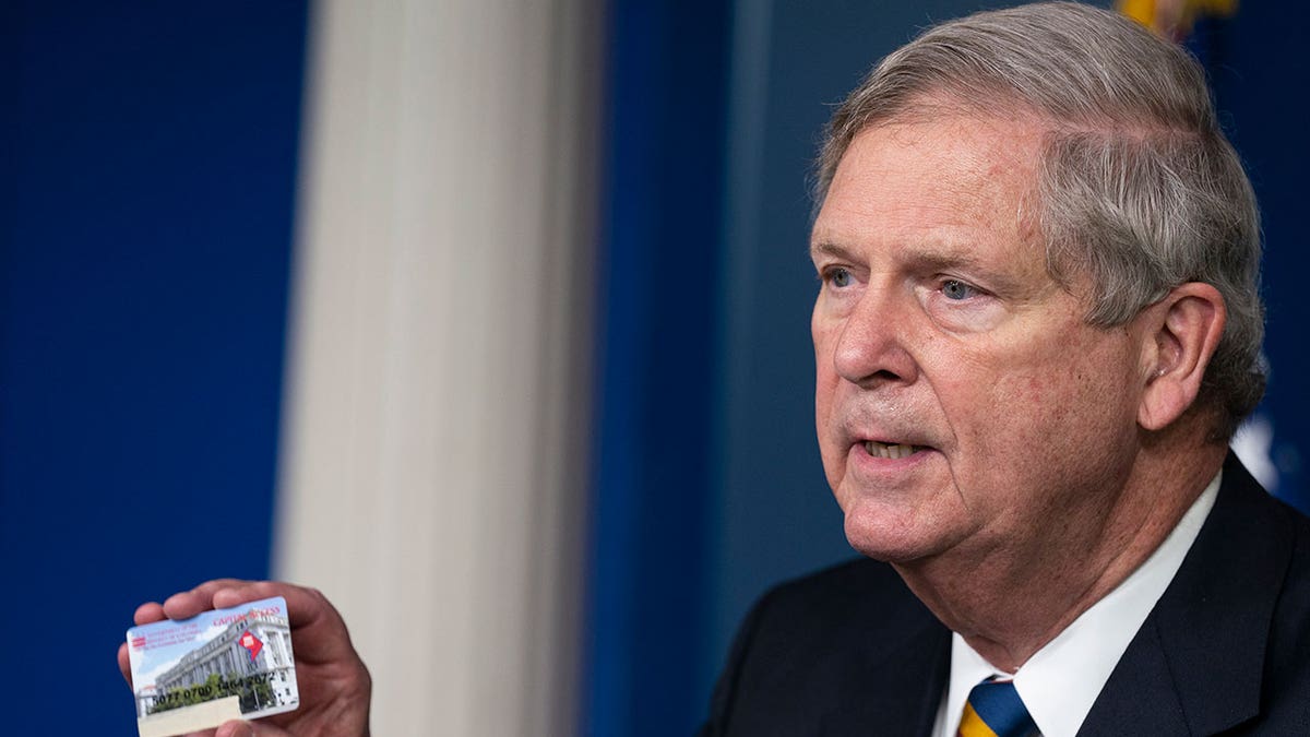 Tom Vilsack holds up SNAP EBT card