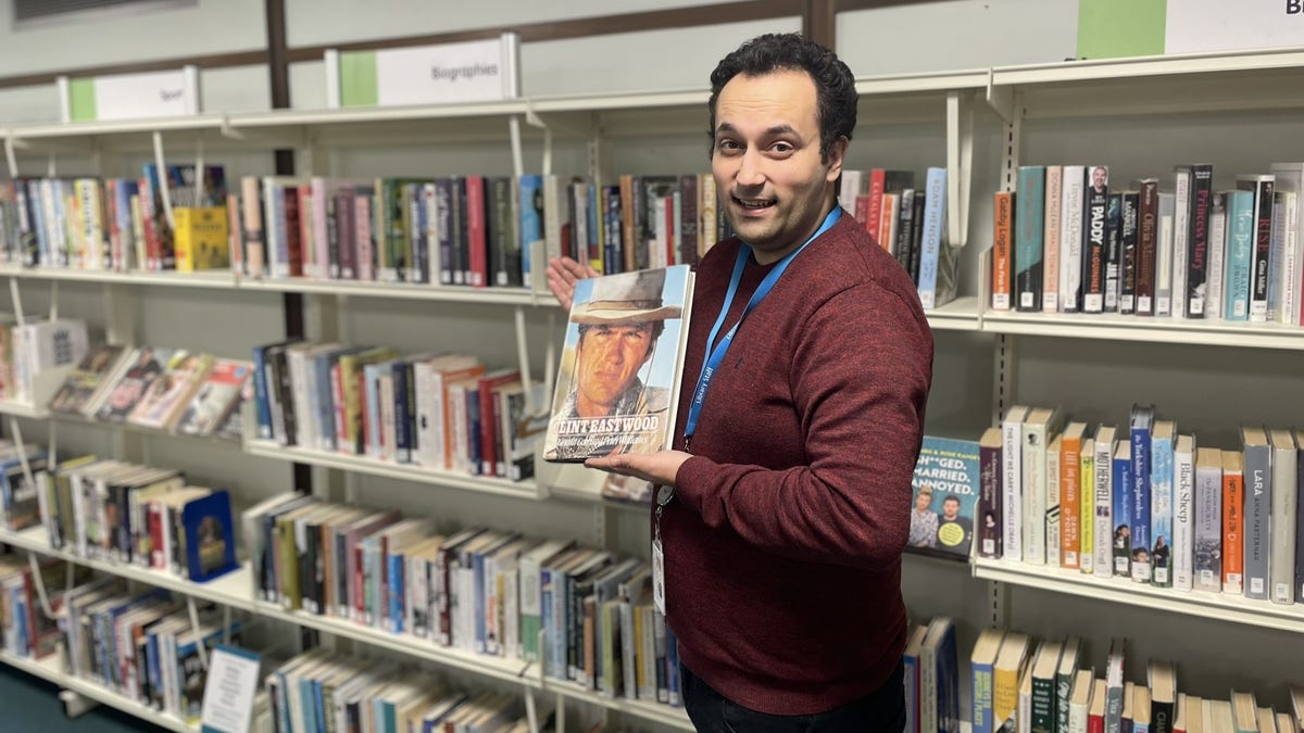 Library assistant holding Clint Eastwood book