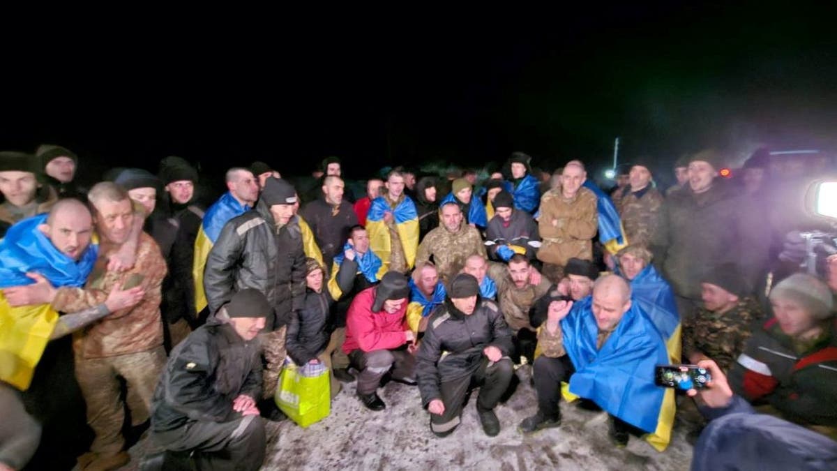 A group of freed Ukrainian POWs celebrate after being released