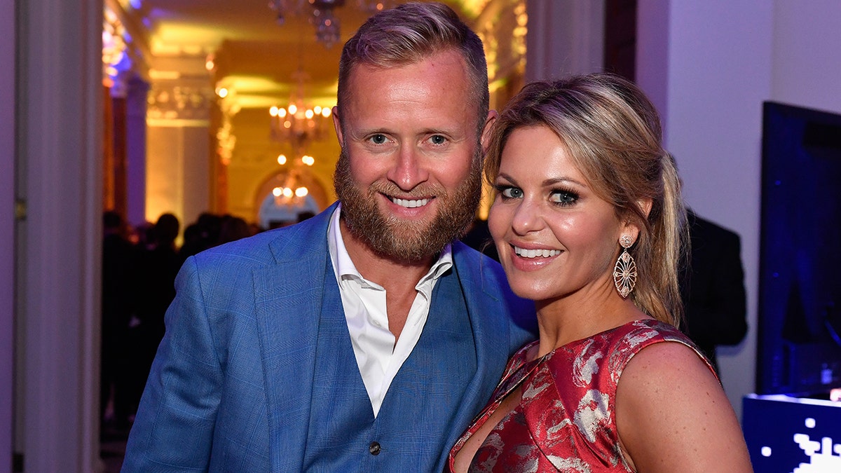 Valeri Bure and Candace Cameron smile for a photo