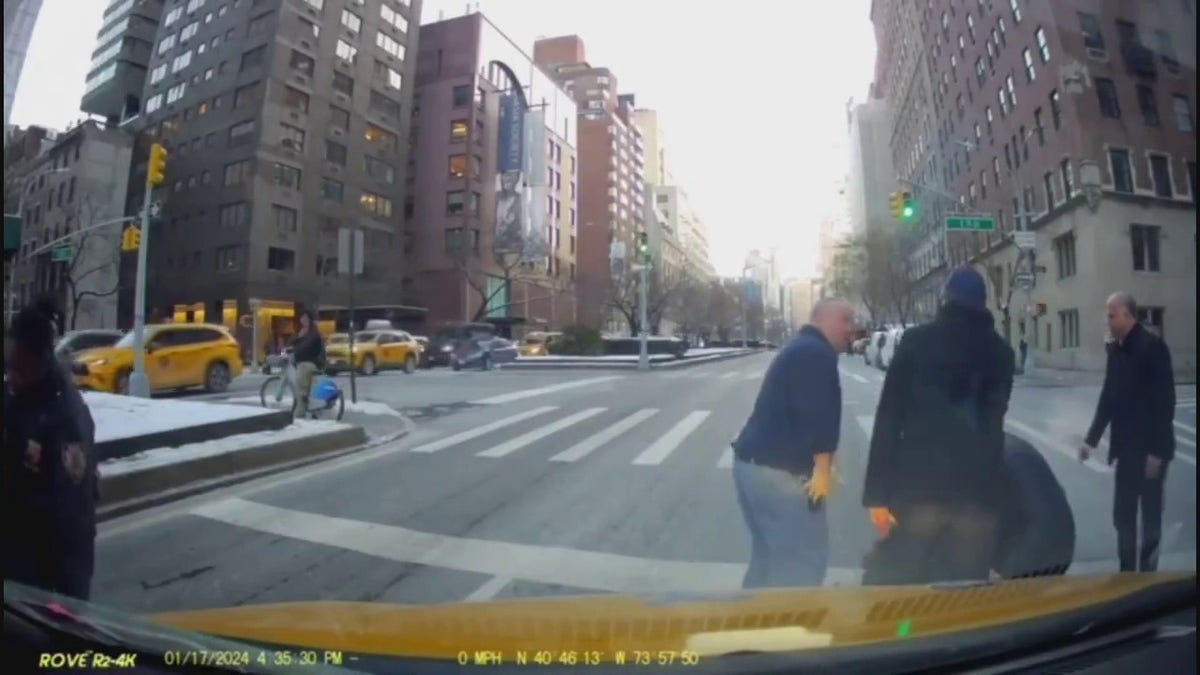 NYPD officers check on wounded officer who was struck by a car