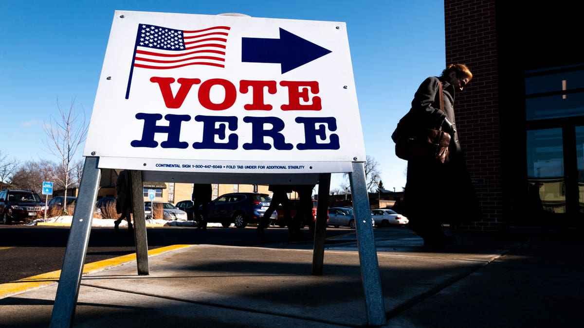 A sign reads "vote here" outside a Minnesota polling location