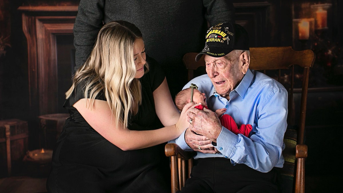 WWII vet holding great great grandaughter