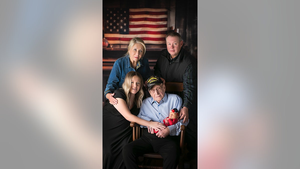 WWII vet holding great great grandaughter