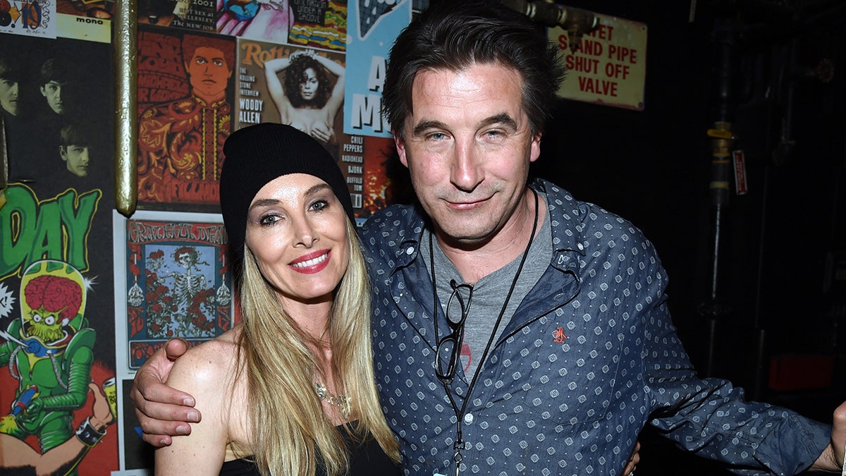 Chynna Phillips wearing a achromatic beanie smiles adjacent to hubby Billy Baldwin successful a bluish patterned shirt