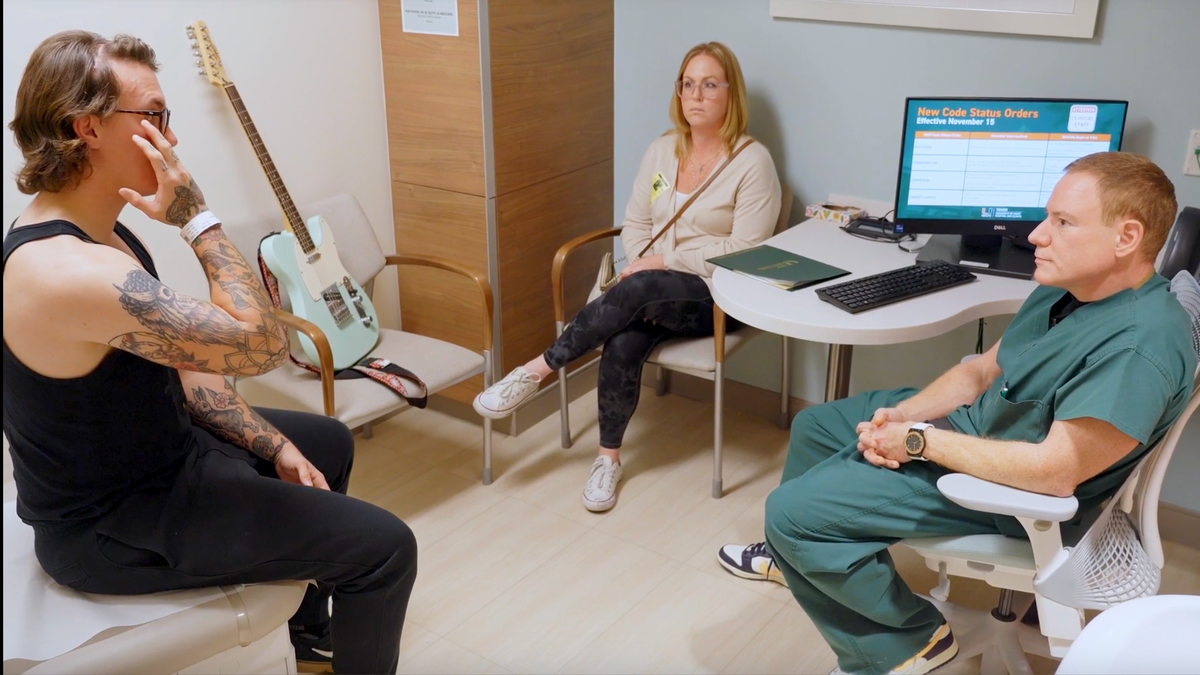 Doctor with patient and family