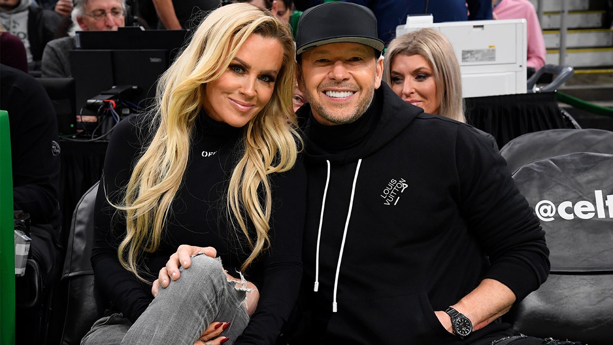 Donnie Wahlberg and Jenny McCarthy courtside at a basketball game