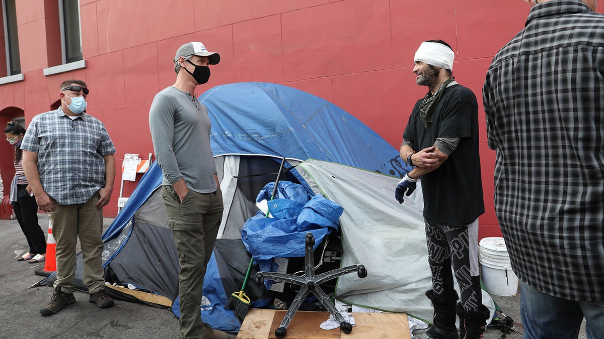 Gavin Newsom in a homeless encampment