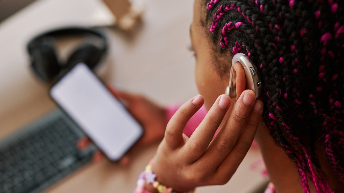 Girl with hearing aid