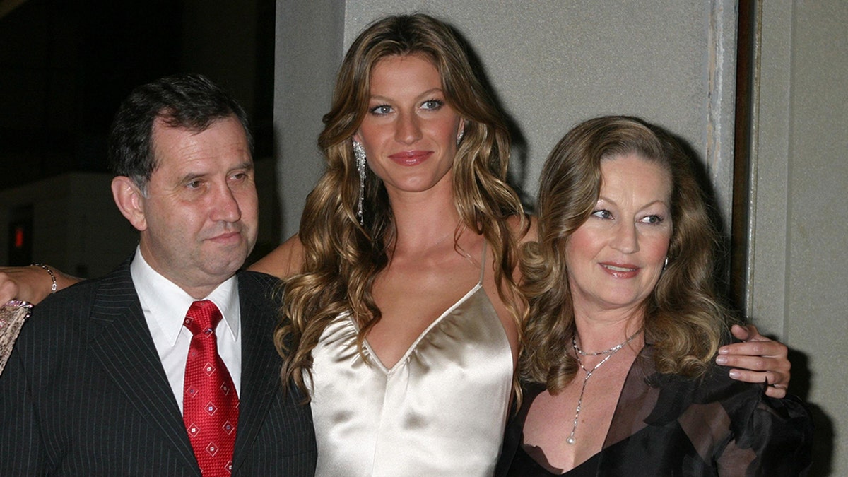 Gisele Bundchen wraps her arms around mom Vania and dad Valdir in New York